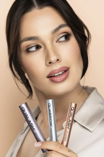 Woman holding QUALASH Advanced Eyelash Growth Serum in premium packaging